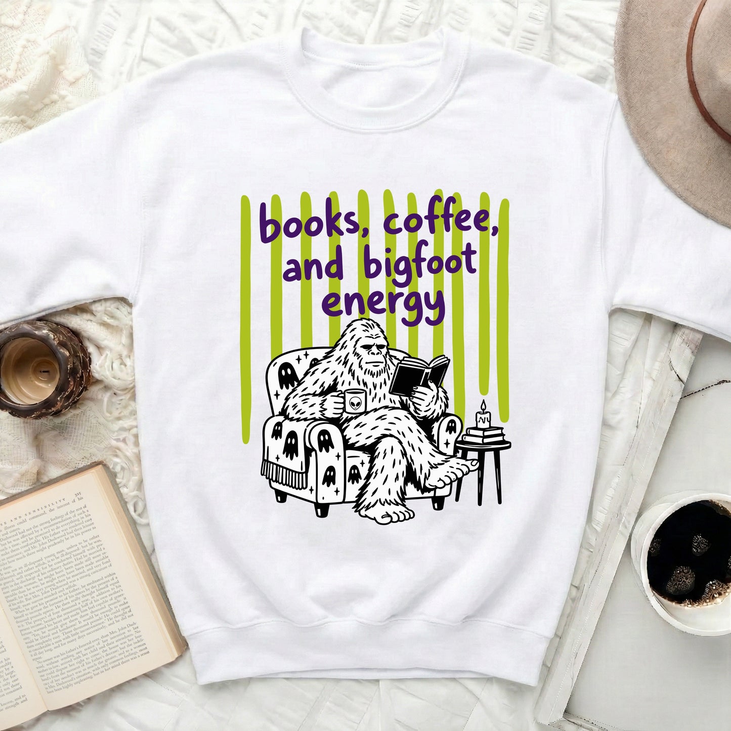 Bigfoot reading a book and drinking coffee with "books, coffee, and bigfoot energy" text.