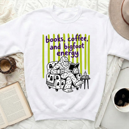 Bigfoot reading a book and drinking coffee with "books, coffee, and bigfoot energy" text.