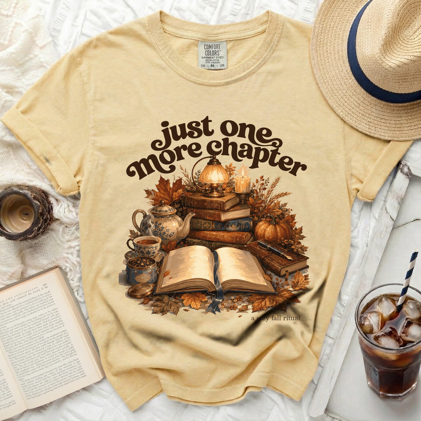 Yellow t-shirt with "just one more chapter" and cozy fall reading graphic.