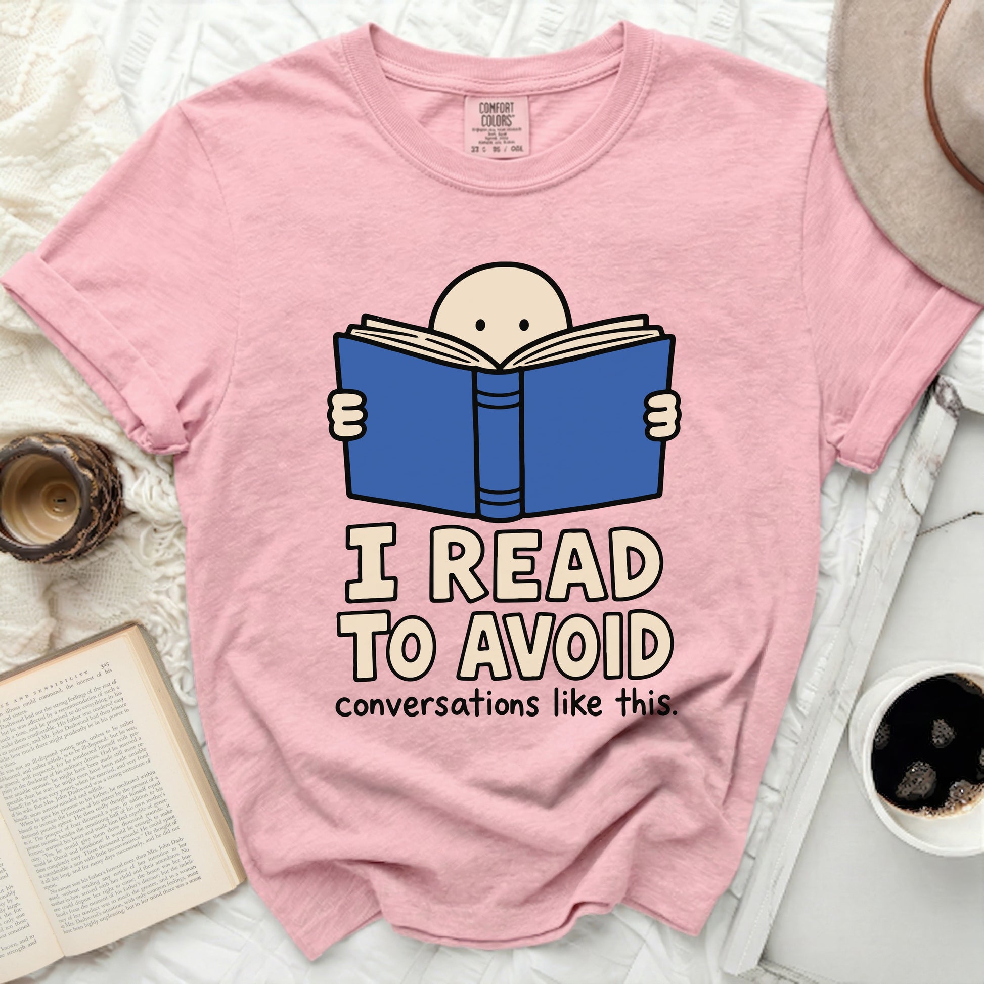 Pink t-shirt with text "I READ TO AVOID conversations like this."