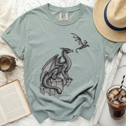 T-shirt with a detailed drawing of two dragons and the text "TEINE & FEIRGE".
