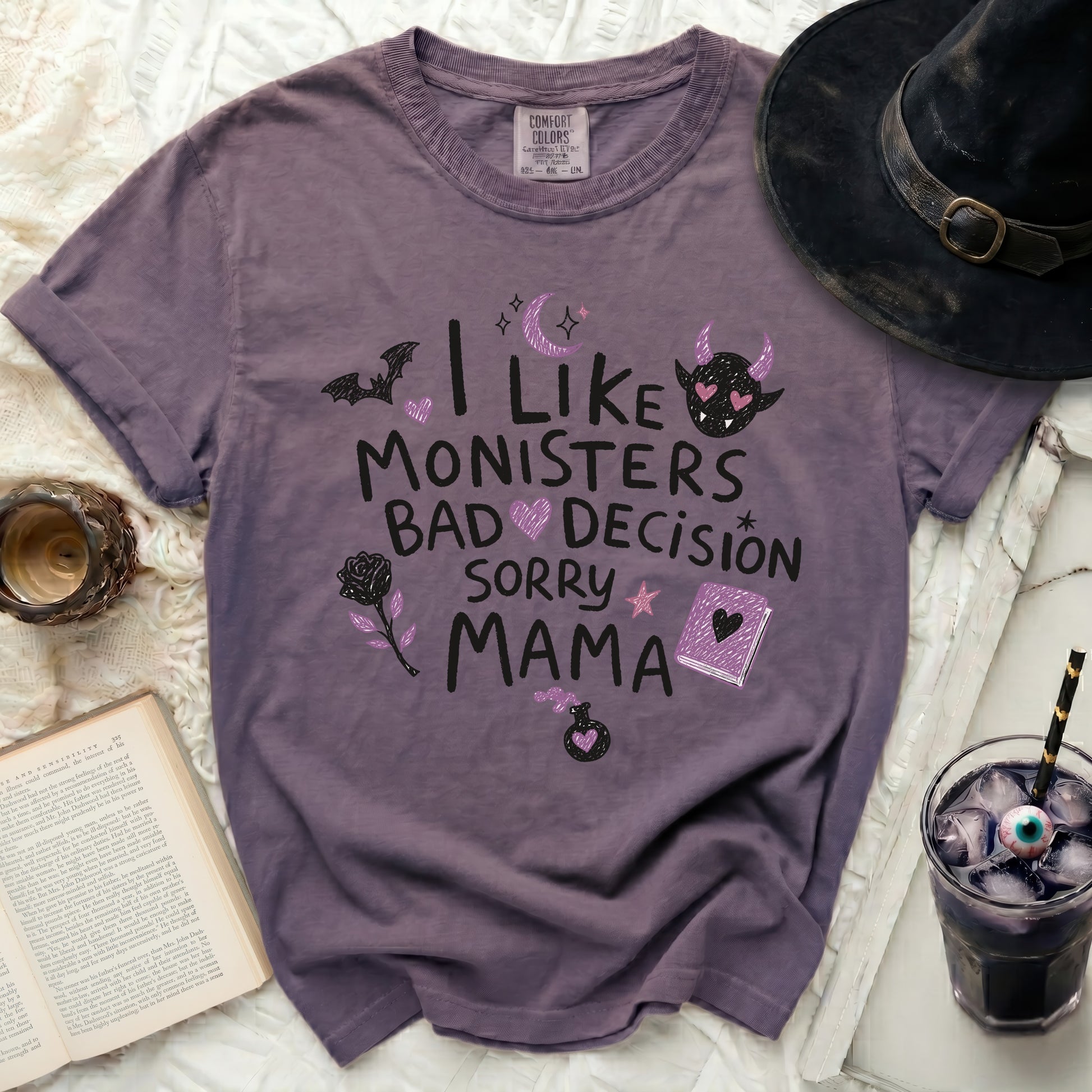 Purple t-shirt with "I like monsters, bad decision, sorry mama" text and Halloween graphics.