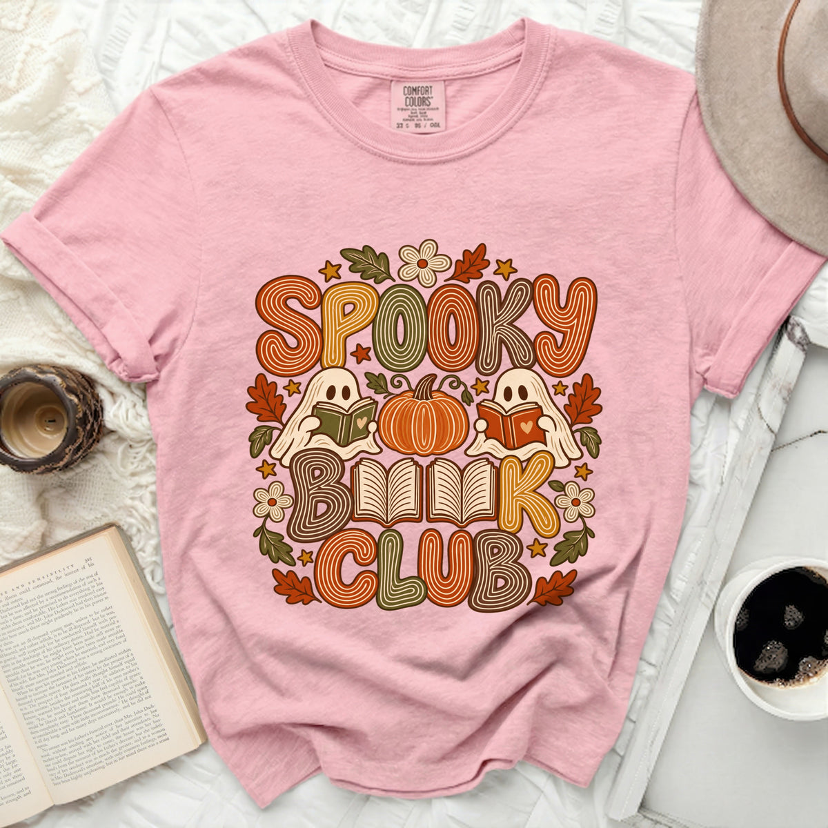 Pink t-shirt with "Spooky Book Club" graphic featuring ghosts, pumpkin, and books.