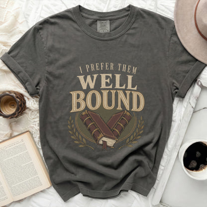 T-shirt with "I PREFER THEM WELL BOUND" and crossed books graphic.