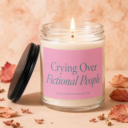 Candle with pink label reading "Crying Over Fictional People".