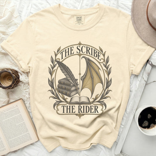 Cream t-shirt with "The Scribe The Rider" text and graphic of books, quill, and wing.