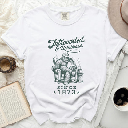 White t-shirt with Bigfoot reading, "Introverted & Unbothered Since 1873".