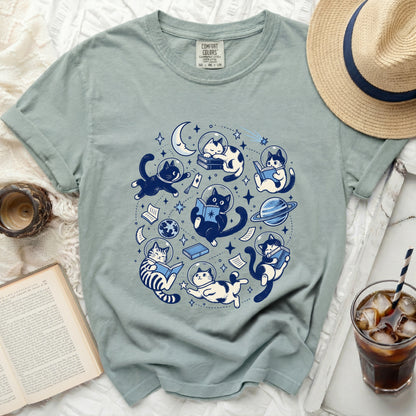 T-shirt with astronaut cats reading in space and celestial elements.