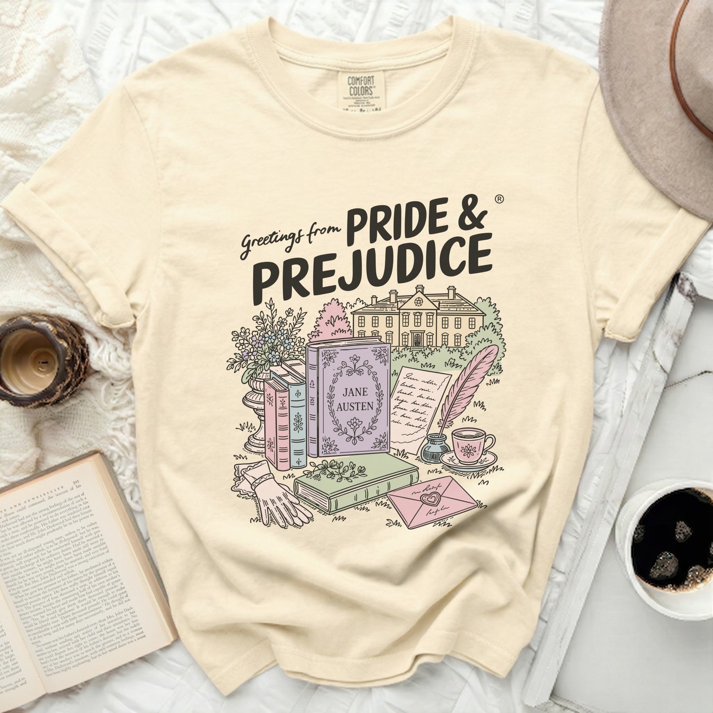Cream t-shirt with Pride & Prejudice graphic featuring books and a house.