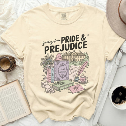 Cream t-shirt with Pride & Prejudice graphic featuring books and a house.