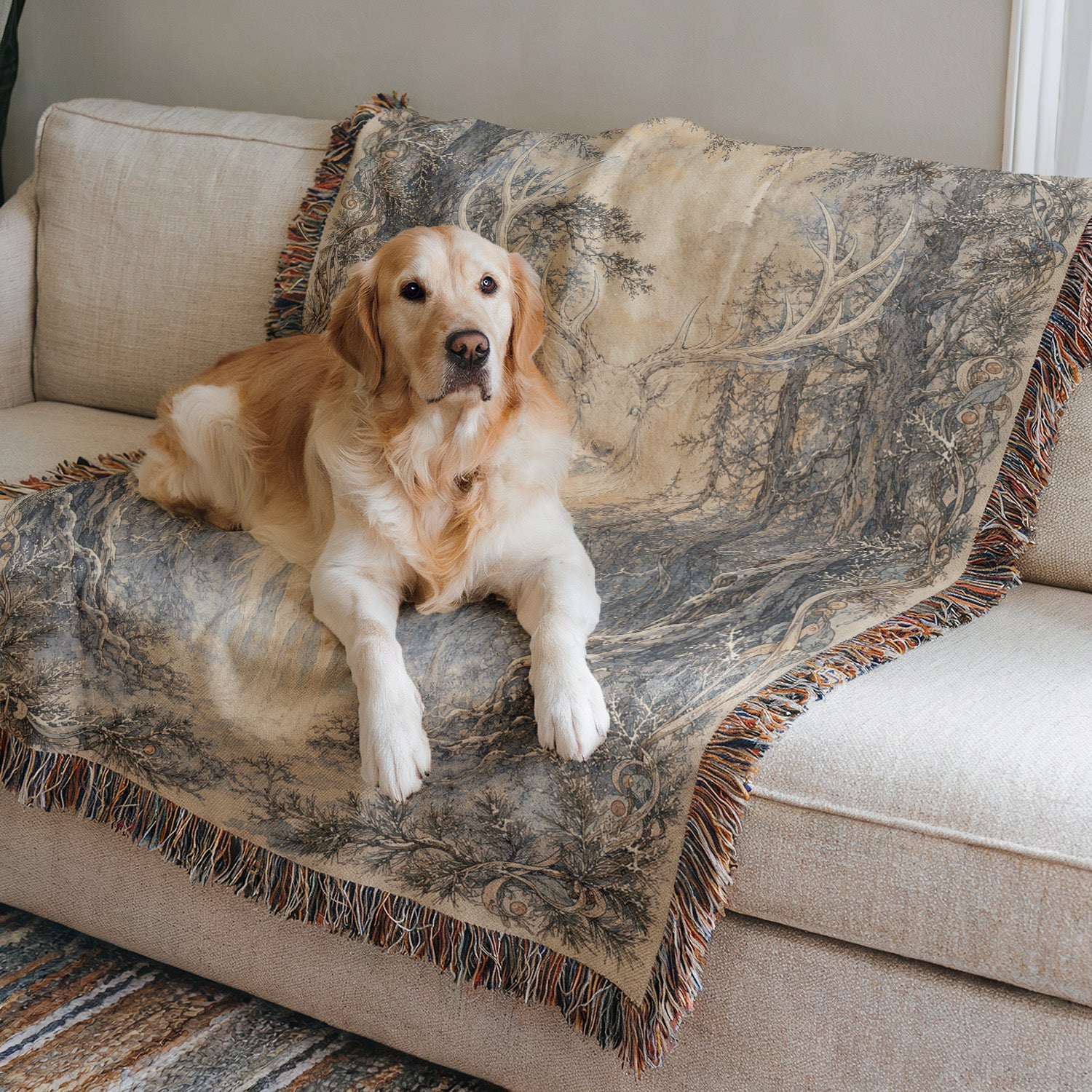 A golden retriever dog is lying on a beige couch, with a gray and white patterned blanket or throw on top.