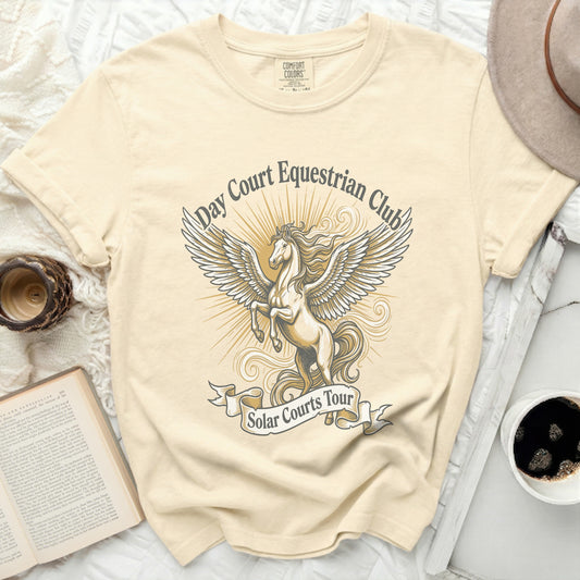 Cream t-shirt with a pegasus graphic and "Day Court Equestrian Club Solar Courts Tour" text.