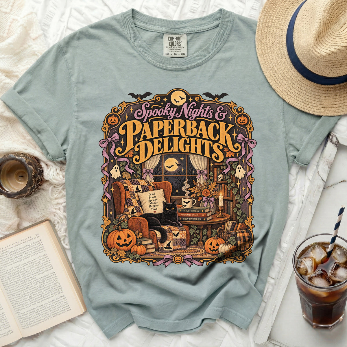 T-shirt with "Spooky Nights & Paperback Delights" Halloween graphic featuring a black cat and pumpkins.