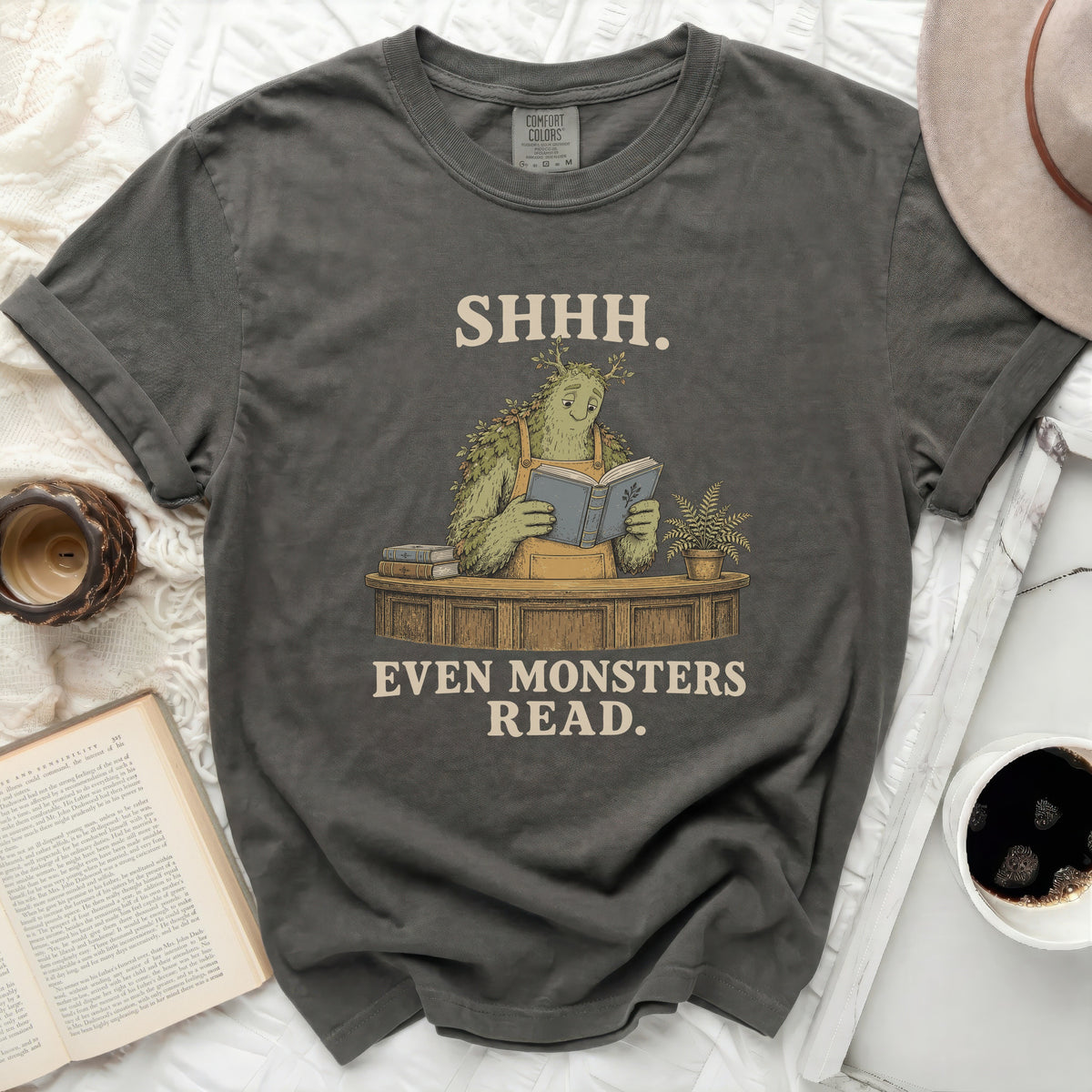 Green monster reading a book with "SHHH. EVEN MONSTERS READ." text.