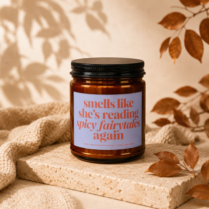 Amber candle with label reading "smells like she's reading spicy fairytales again".