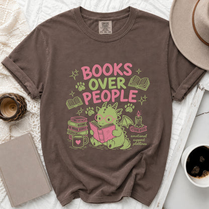 Brown t-shirt with "BOOKS OVER PEOPLE" text and a cartoon dragon reading amidst books.