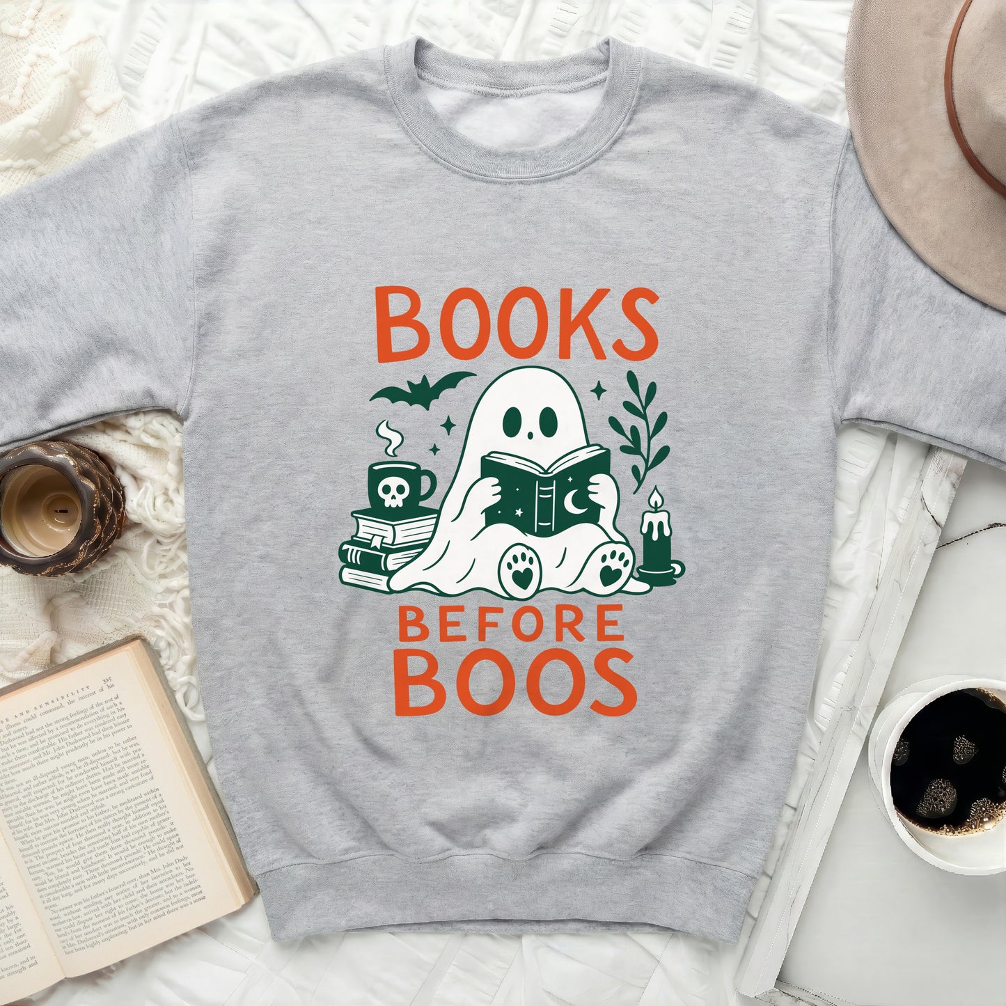 Ghost reading book with text BOOKS BEFORE BOOS