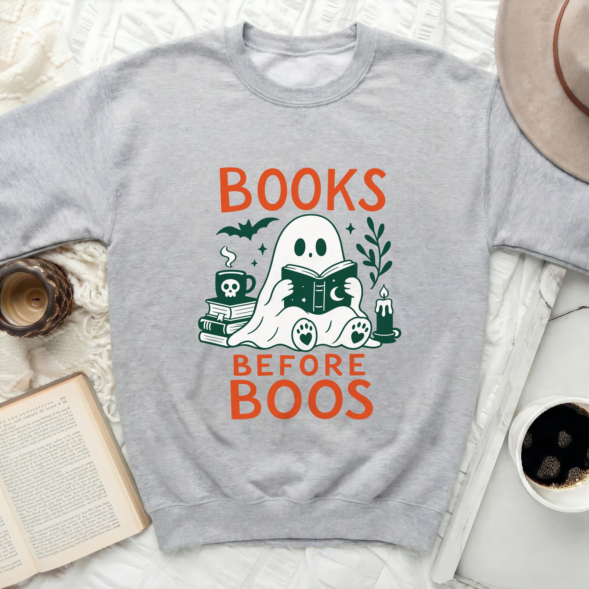 Ghost reading book with text BOOKS BEFORE BOOS