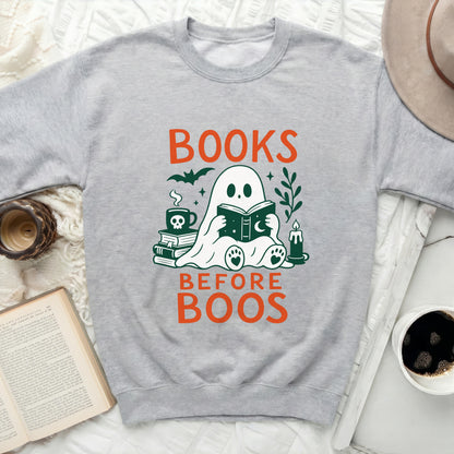 Ghost reading book with text BOOKS BEFORE BOOS