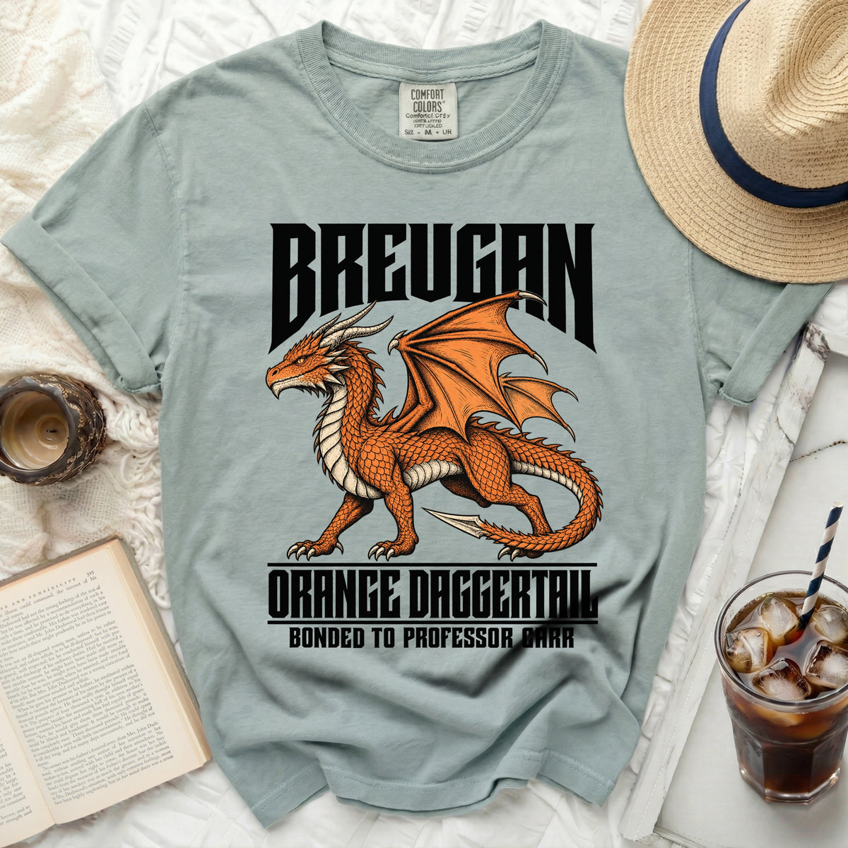 Light blue t-shirt with "BREUGAN" above an orange dragon, "ORANGE DAGGERTAIL," and "BONDED TO PROFESSOR DARR."