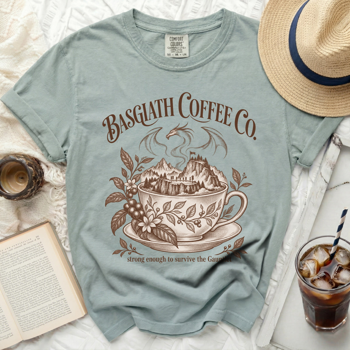 Basgiath Coffee Co. dragon and mountains graphic on a light blue shirt.
