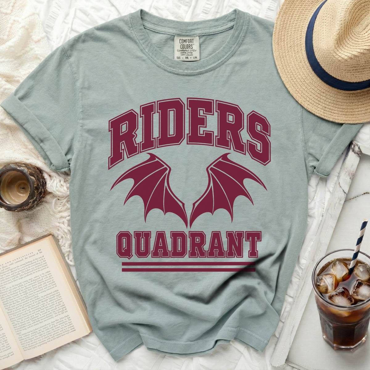 Light blue t-shirt with "RIDERS QUADRANT" and winged graphic.