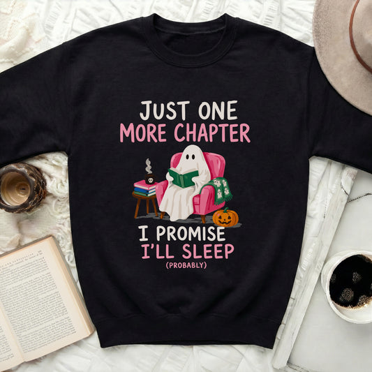 Black sweatshirt with ghost reading under "Just One More Chapter I Promise I'll Sleep".