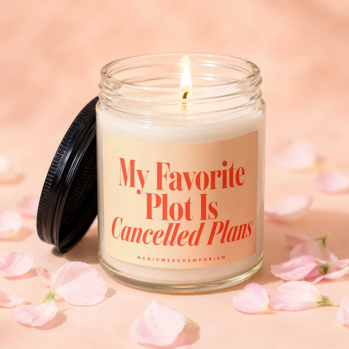 Candle with lit wick and label reading "My Favorite Plot Is Cancelled Plans".