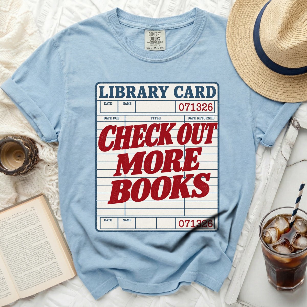 Light blue t-shirt with "Library Card Check Out More Books" graphic.
