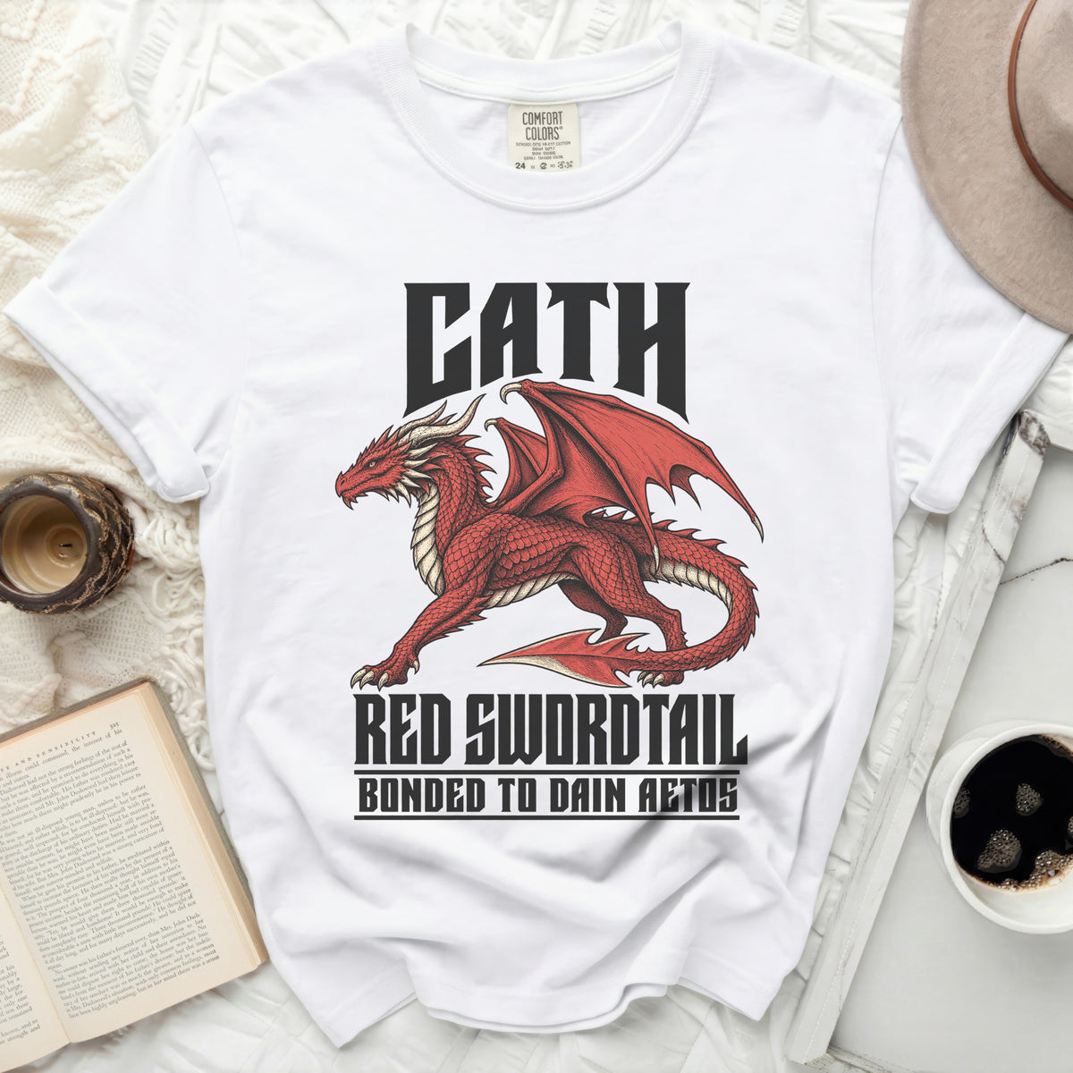 White t-shirt with a red dragon design and text "CATH RED SWORDTAIL BONDED TO DAIN AETOS".