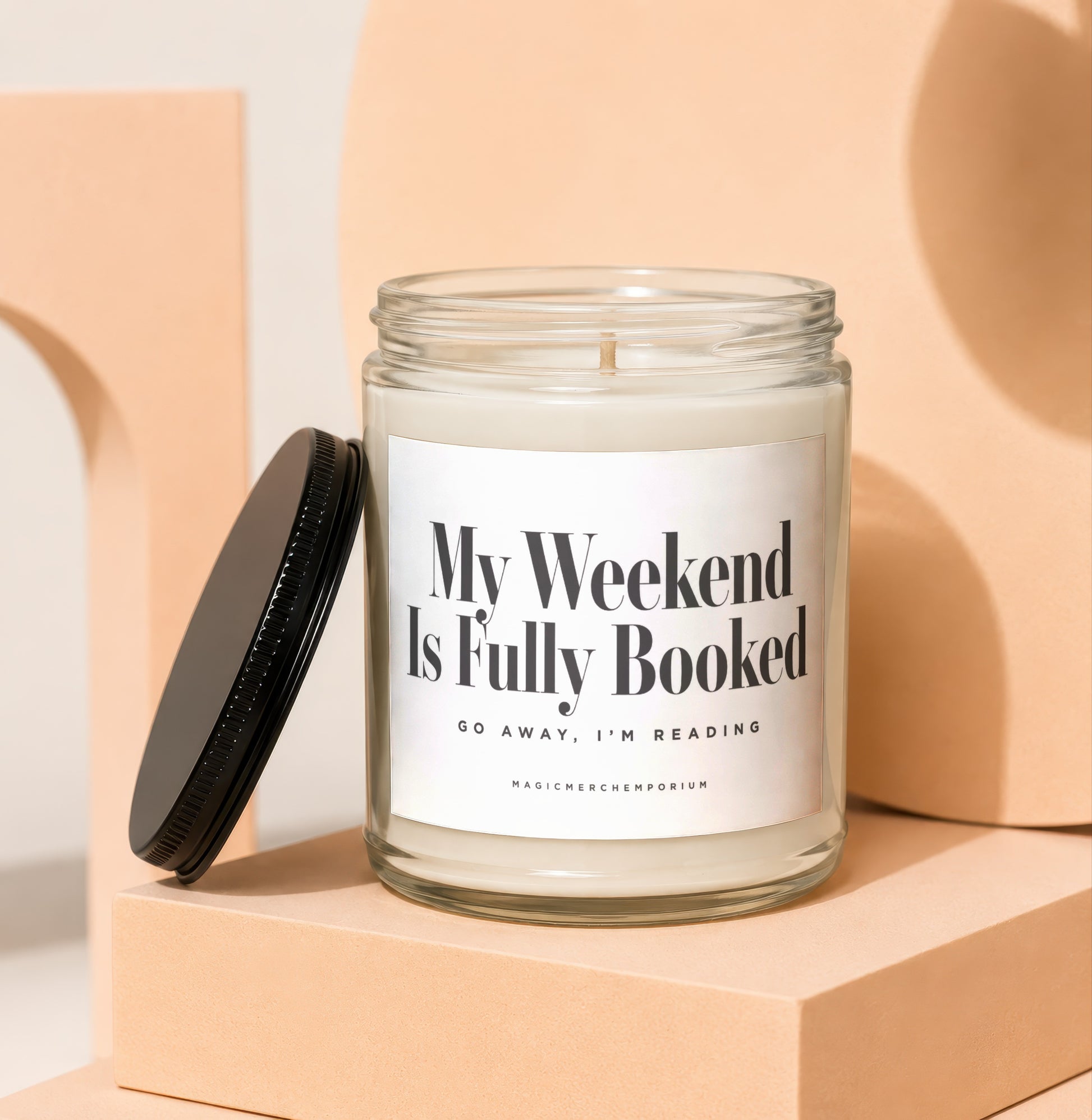 Glass candle with "My Weekend Is Fully Booked" text and black lid.