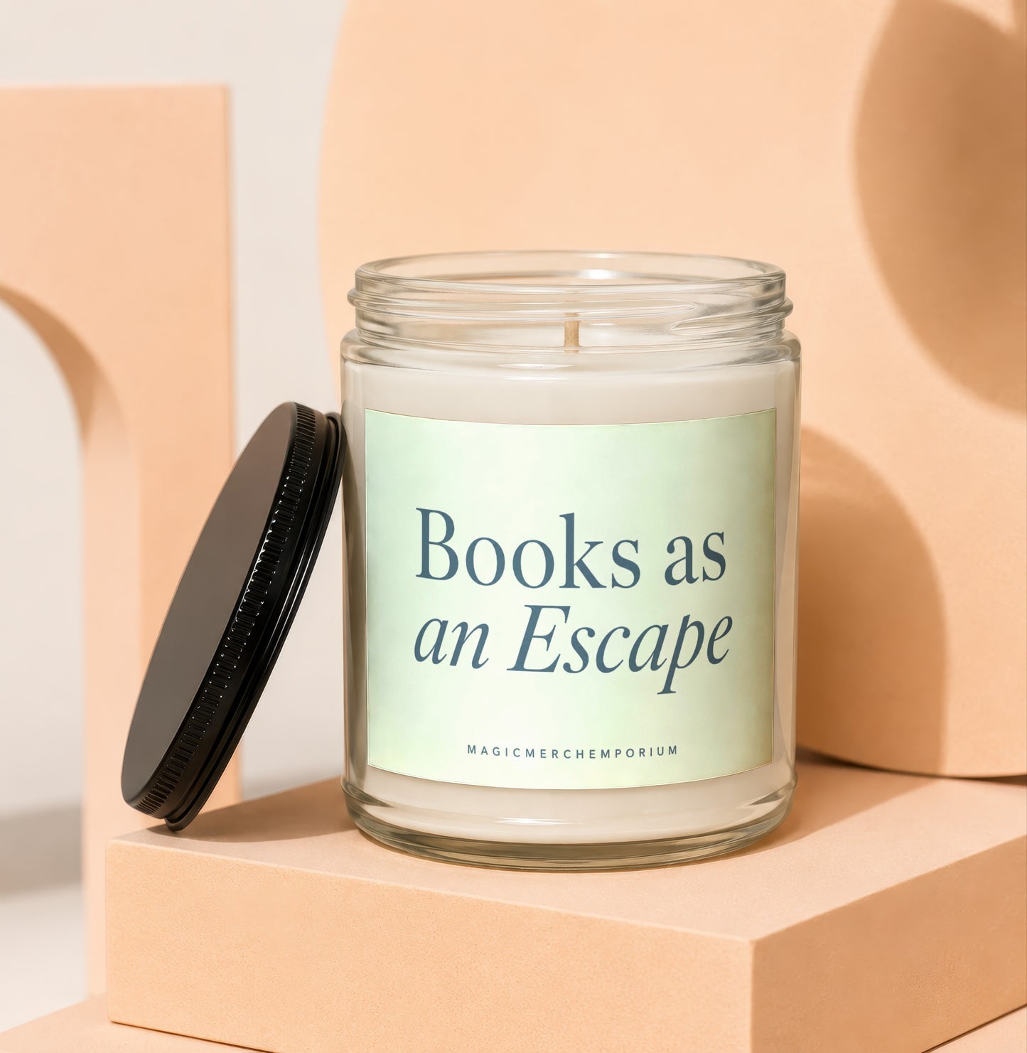 Candle with text "Books as an Escape" and "MAGICMERCH`EMPORIUM" on label.