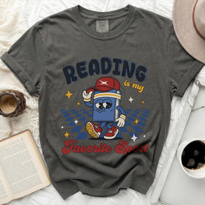Graphic tee with cartoon book saying "Reading is my Favorite Sport."