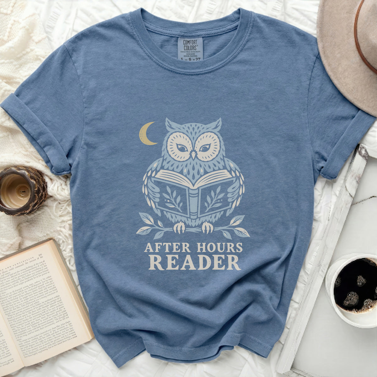 Blue t-shirt with an owl reading a book and "After Hours Reader" text.