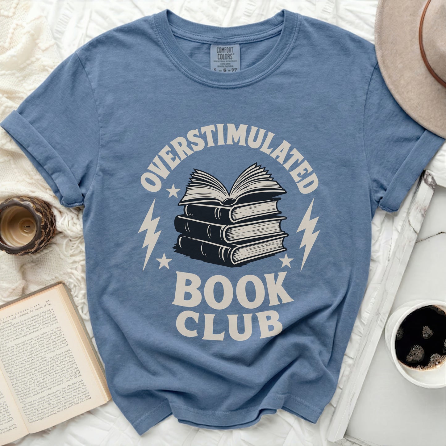 Blue T-shirt with "Overstimulated Book Club" and stack of books graphic.