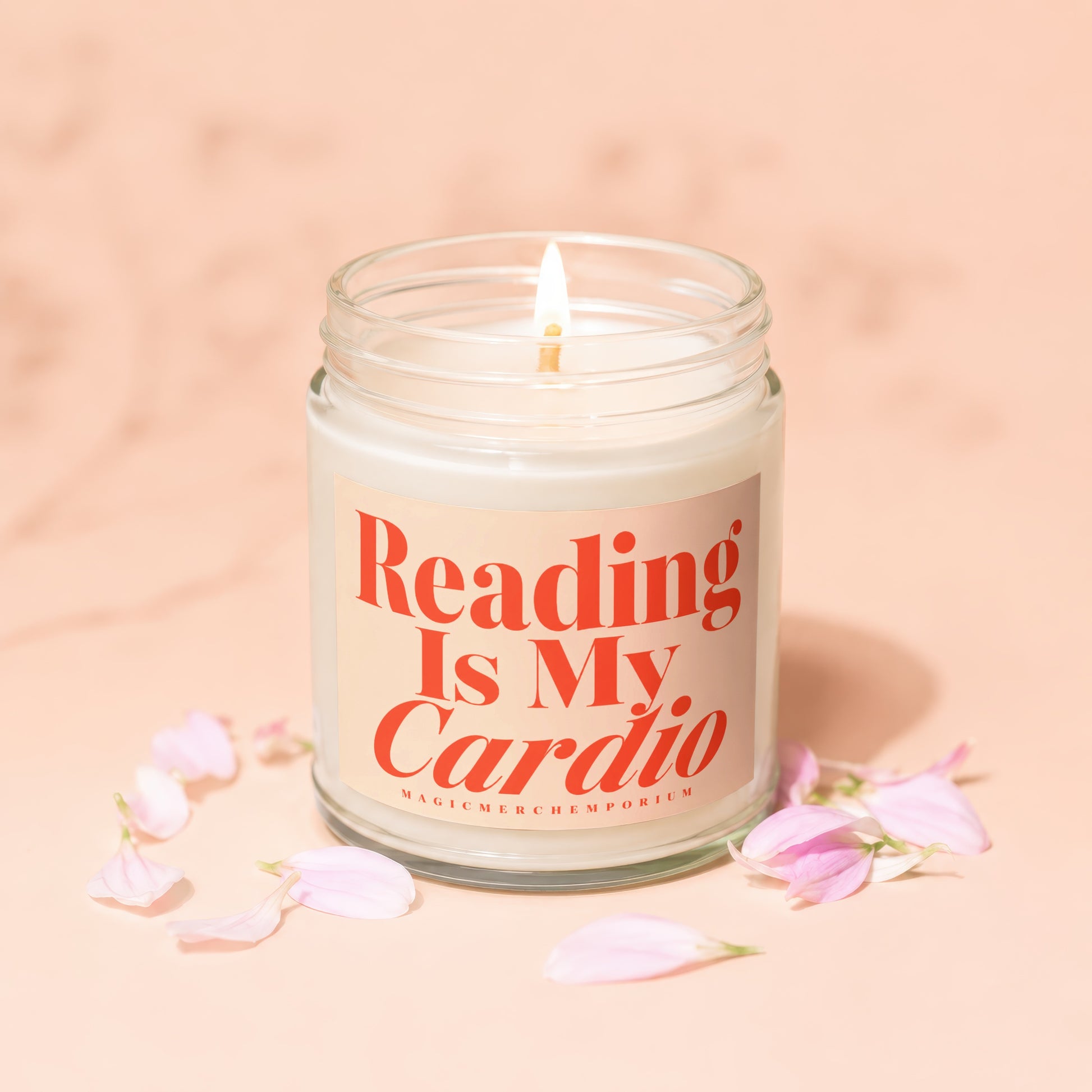 Candle with "Reading Is My Cardio" text and pink flower petals.