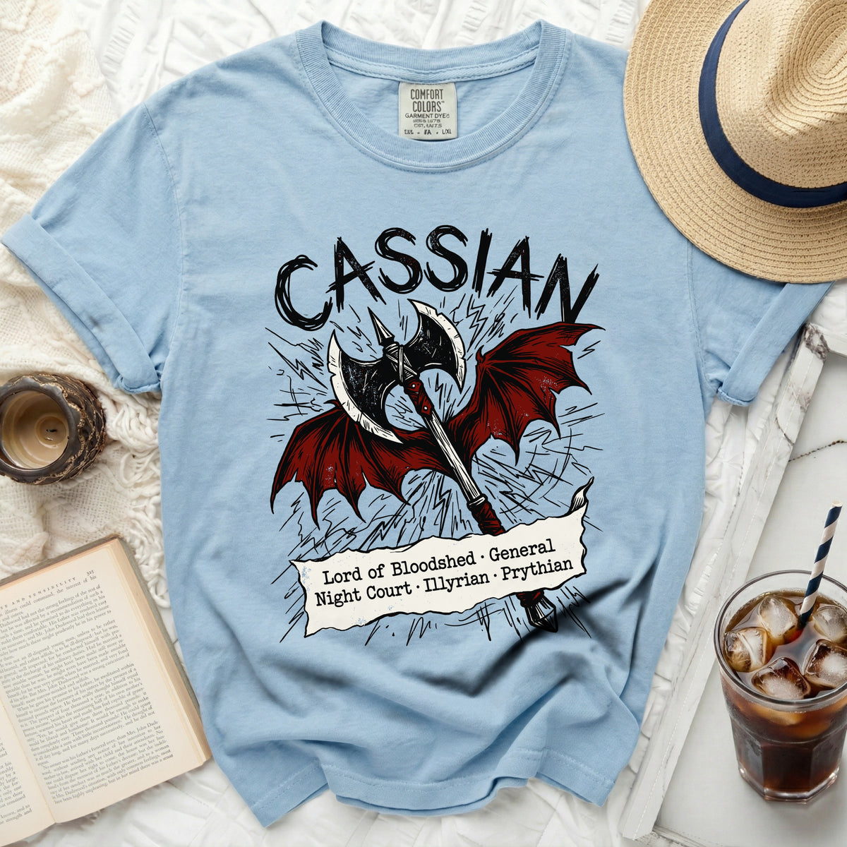 Light blue t-shirt with "Cassian" and an axe with wings and text.