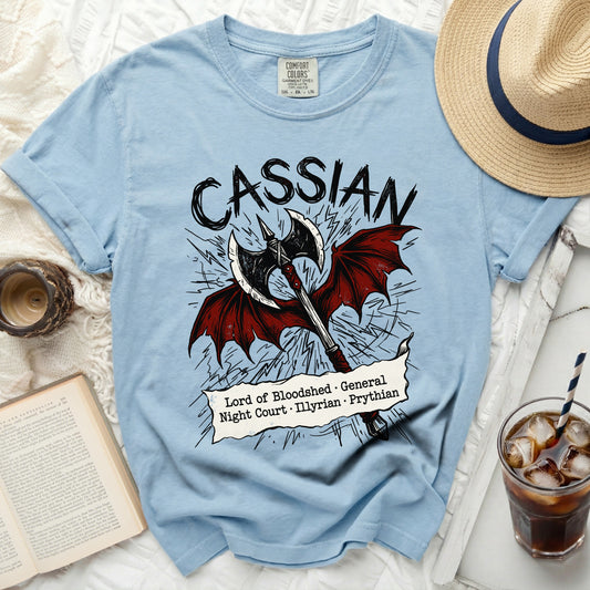 Light blue t-shirt with "Cassian" and an axe with wings and text.