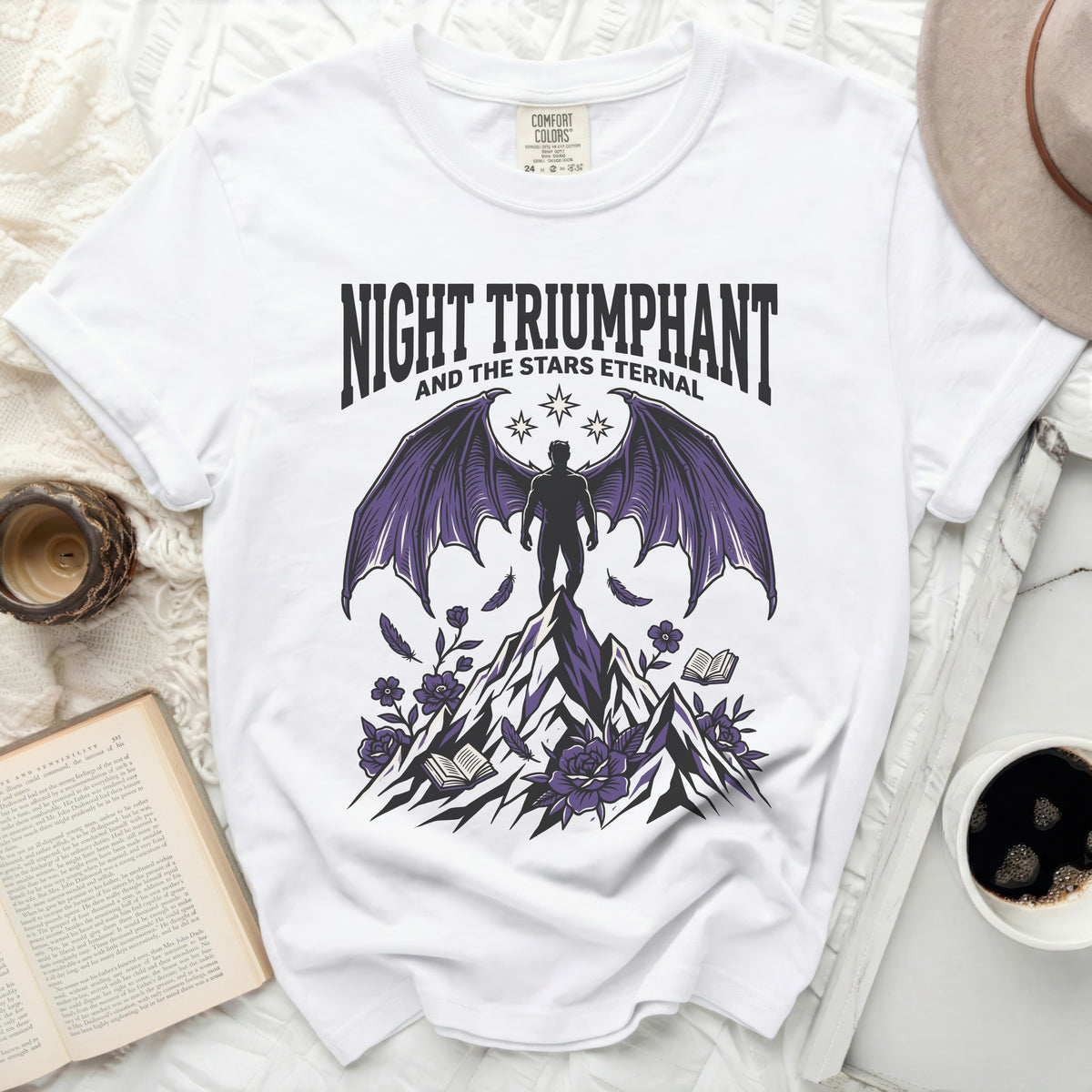 "Night Triumphant and the Stars Eternal" graphic on a white t-shirt.