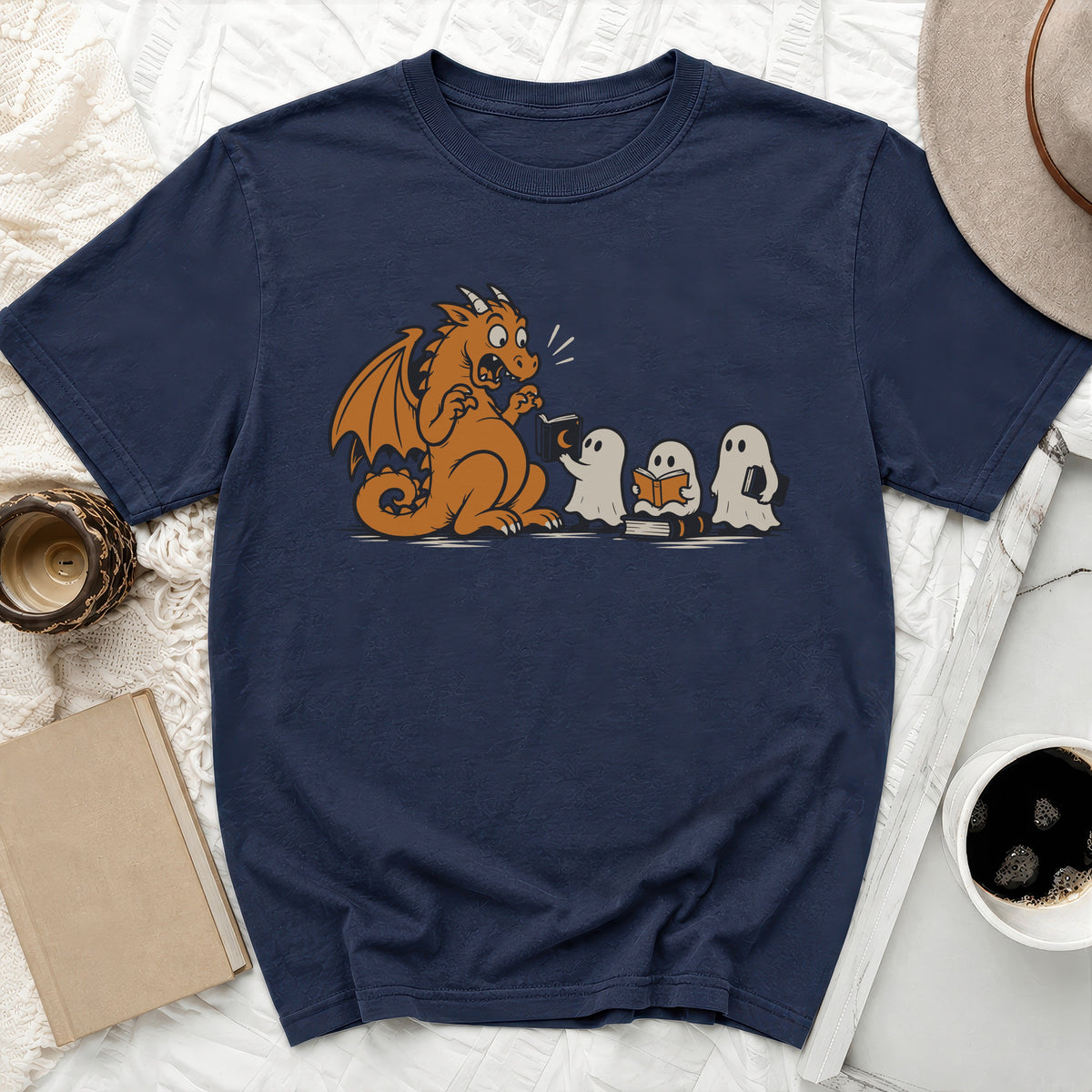 Navy t-shirt with a cartoon dragon and ghosts reading books graphic.