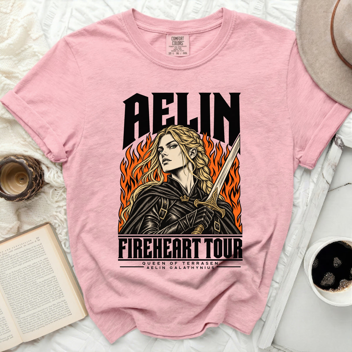 Pink t-shirt with "Aelin Fireheart Tour" graphic of a woman with sword.
