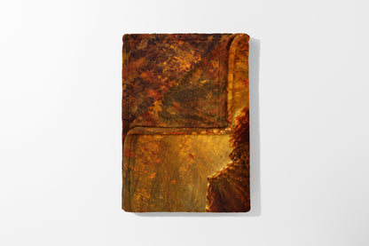 Tapestry with textured print of a figure in a forest clearing illuminated by golden light.
