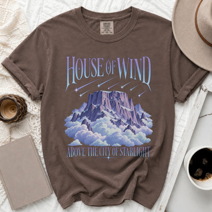 Brown t-shirt with "House of Wind" above a mountain in clouds.