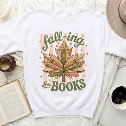 White sweatshirt with "fall-ing for BOOKS" text and leaf made of books.