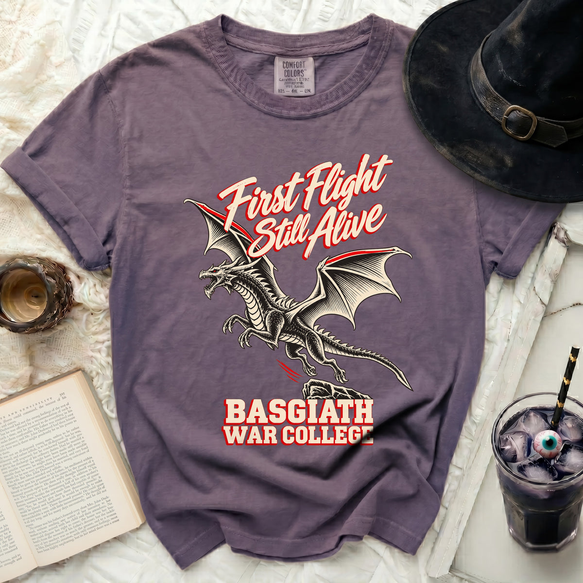 Purple t-shirt with a dragon and text "First Flight Still Alive Basgiath War College".