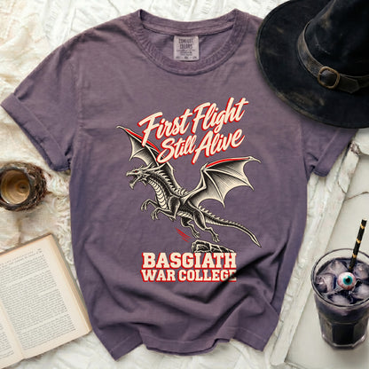 Purple t-shirt with a dragon and text "First Flight Still Alive Basgiath War College".