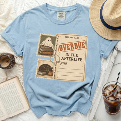 Light blue t-shirt with "Overdue in the Afterlife" library card graphic.