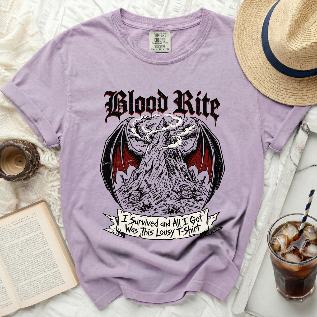 Purple t-shirt with "Blood Rite" and a graphic of a mountain, wings, and a banner.