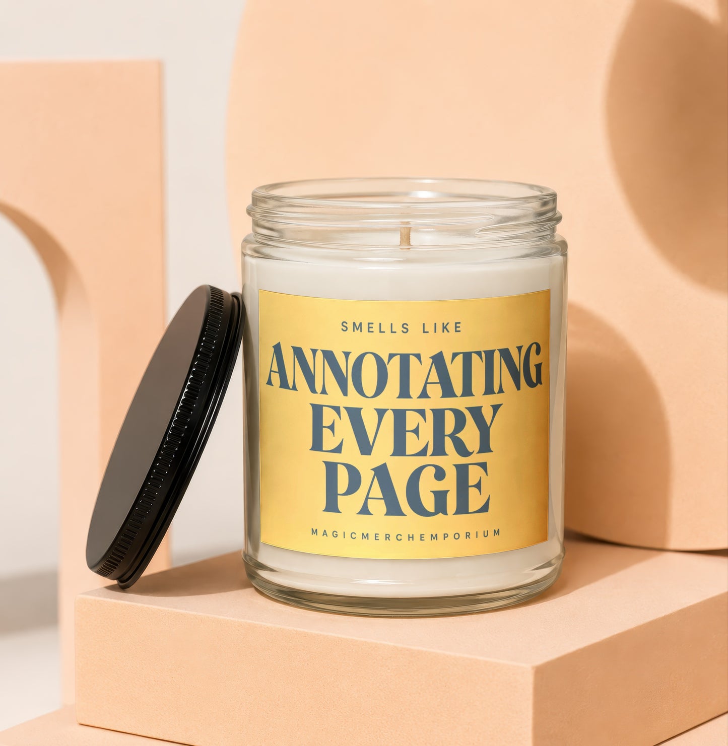 Glass candle with yellow label reading "Smells Like Annotating Every Page"