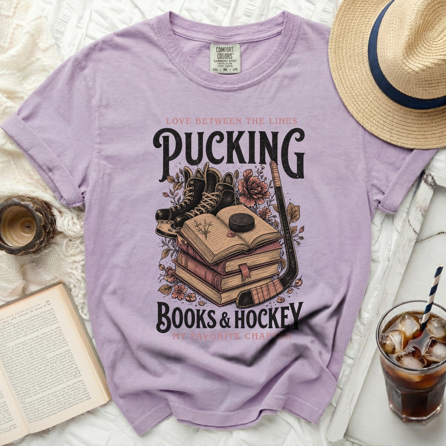 Purple t-shirt with "Pucking Books & Hockey" text and hockey graphics.